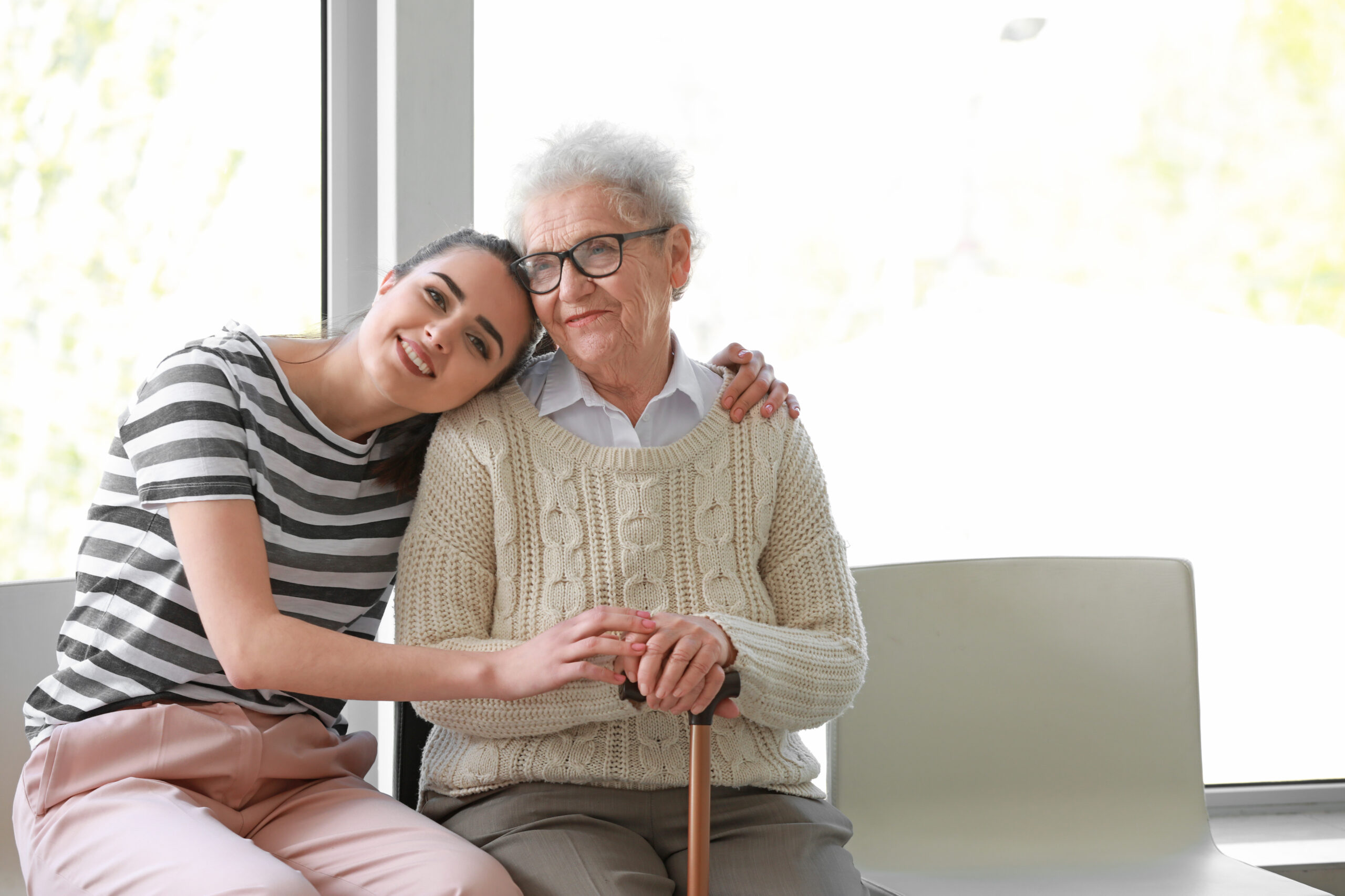 Caregiver with senior woman in nursing home