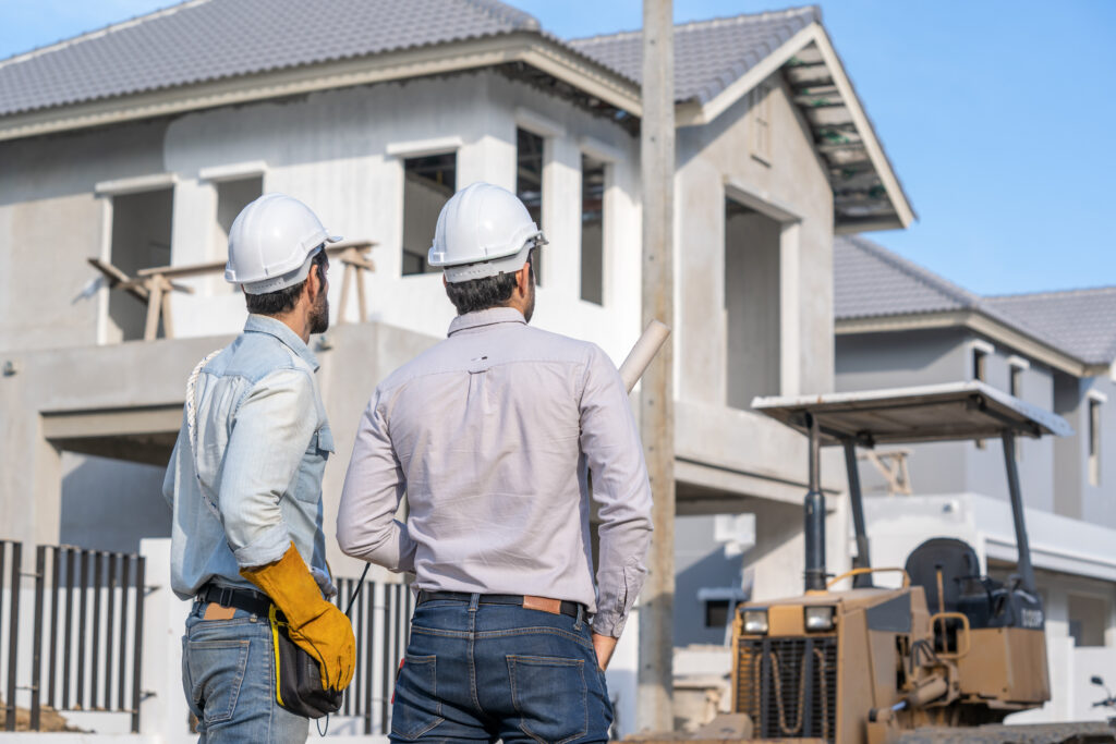 Engineer and technician team discussing in new home construction site.,Colleagues working together,Construction engineering occupation project.