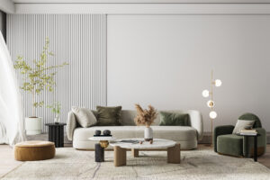 Green chair sitting in a living room with a white couch, plants, against a white wall